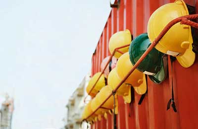 Safety hard hats on the wall at the construction site